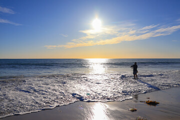 man fishing on beach