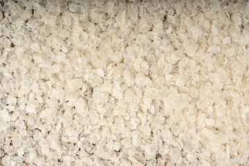 Raw flattened rice textured background. Dry rice flakes or poha pattern, Indian breakfast food