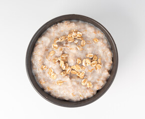 Cooked spelt in bowl. Oatmeal milk porridge, boiled emmer or spelt, healthy cereal food