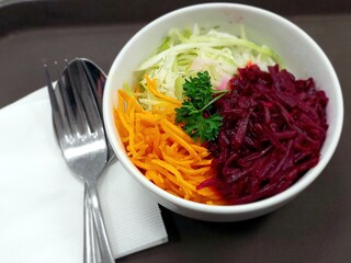 Fresh Salad Made With Parsley, Red Beet, Carrot, and Cabbage Served in a Bowl