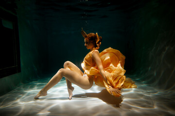 Underwater Elegance A Beautiful Lady in a Flowing Golden Dress Captivating All Around Her