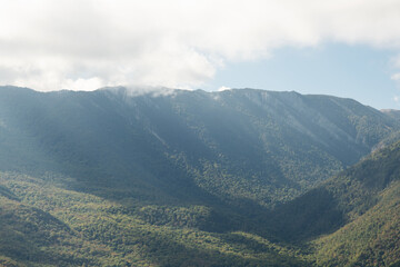 beautiful mountain landscape with clouds upper them. autumn time