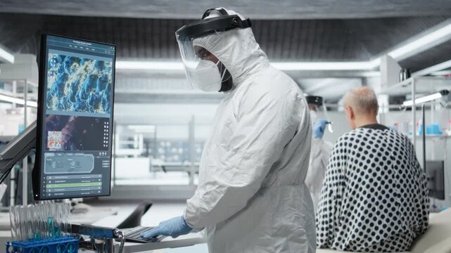 Scientist in hazmat suit checking DNA molecules of infected patient in a bioscience lab, analyzing pathology and virology data, testing immunology theories and developing vaccines. Camera B.