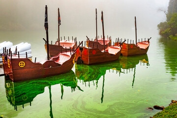 Viking shaped pedal boat in the Black Lake in a fog day. Gramado is a hot spot tourist city. It’s...