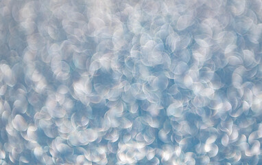 Glitter shimmer background. Defocused shimmer. Bokeh backdrop shimmer. Bokeh effect. Glitter shine. Bokeh shimmering background. Blurred defocused background. Blur glitter backdrop. Glitter sparkles