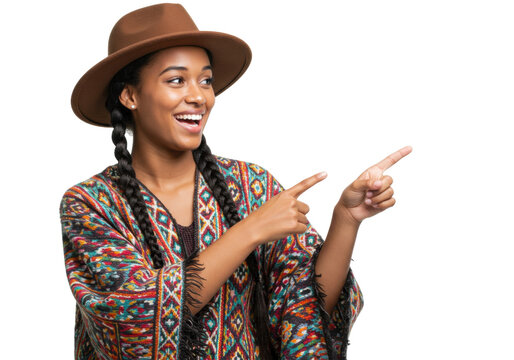 Smiling woman with hat and colorful poncho isolated on transparent PNG, pointing to the side with happy expression and braided hair