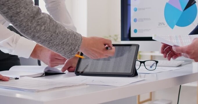 Close up of business people standing on workplace, discussing paper financial report in charts, diagrams and graphs, analysing data and sales statistics on tablet. Teamwork and cooperation concept.