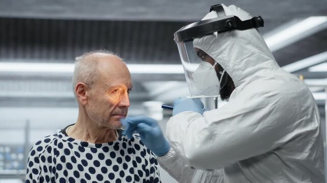 Black medic in quarantine facility provides medical care to patient during outbreak, collecting data on disease, drug treatment and vaccine testing for global epidemic prevention. Camera B.