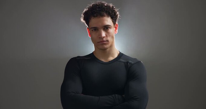 Workout, arms crossed and face of man in studio for health, personal trainer and fitness. Exercise athlete, training coach and wellness with person or bodybuilder on background for mockup space