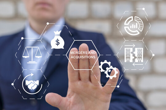 Person using virtual touch screen presses the words MERGERS AND ACQUISITIONS. Mergers and acquisitions business concept. Merger and Acquisition Corporate Cooperation Companies. M&A deal partnership.