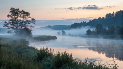 A foggy river reflecting the sunrise in a beautiful landscape