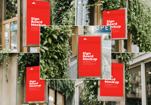 Set of Vertical Signboard Mockups on a Glass Wall Surrounded by Dense Greenery