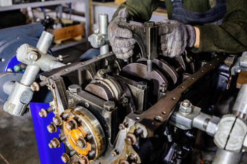 Fototapeta premium Process of assembling or repairing engine, close up
