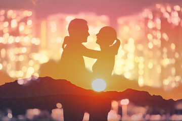 Joyful man and woman embracing laughing smiling in a city sunset setting 