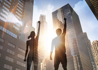 man woman raising fists in celebration business people unity success in the city 