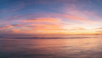 Fototapeta premium Morning sky with glowing cirrus clouds over calm ocean water at sunrise 