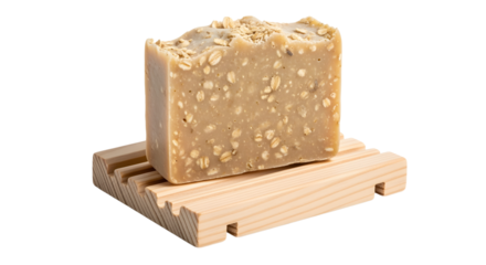 Close up of a bar of oatmeal soap on a wooden soap dish against a white background