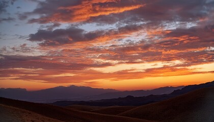 Fototapeta premium Orange Evening Sky with Cirrus Clouds and Mountain Silhouette 