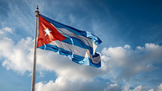 Majestic Cuban flag proudly wave against beautiful blue sky with white cloud, patriotic banner symbolizing freedom, independence, and pride