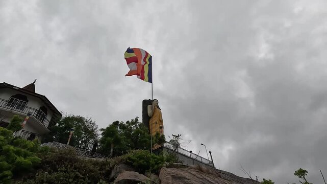 Buddhist Flag Waving at Kirinda Temple, Sri Lanka, Spiritual and Cultural Landmark