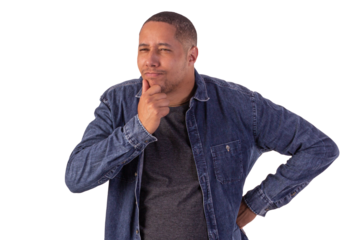 Young adult man wearing a blue denim jacket, with a white shirt in studio shots with a pink background and making various facial expressions showing various feelings