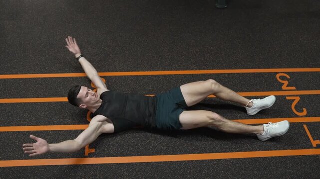 Sporty man training abs. Sixpack leg crunches exercise. Muscular sportsman do abs workout. Abdominal exercise. Exercise for abs sixpack torso muscle. Leg crunches man in training, 4k