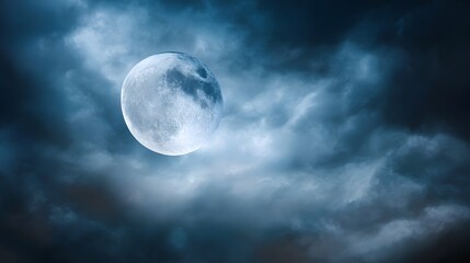 Obraz premium Glowing full moon emerges from dark stormy clouds at night.