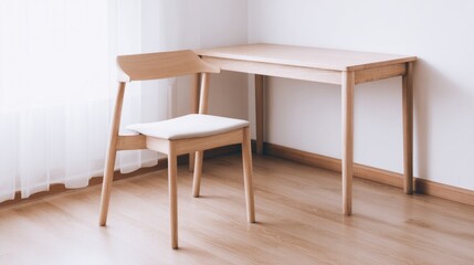 organized. A clean and simple office corner featuring a wooden desk and chair under soft natural light. real-estate listings.
