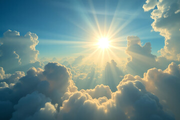 Bright sun rays shine through fluffy clouds in blue sky
