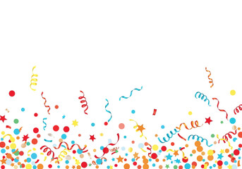 Confetti and streamers with circles and stars scattered across a white surface