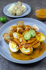 Siomay (also somai) is a Chinese-Indonesian steamed fish dumpling with vegetables served in peanut sauce