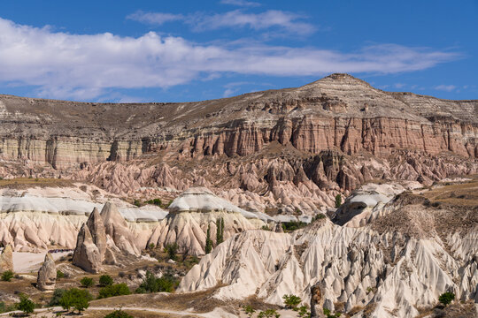G&ouml;reme, Turkey: Panoramic view of Rose Valley in G&ouml;reme. Famous landscape of rock formation with trekking trail in Nevsehir, Cappadocia, Turkey. Taken on blue sunny day
