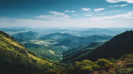 Fototapeta premium Rolling green mountains stretch to the horizon under a blue sky.
