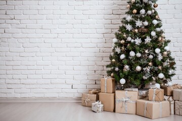 Christmas Tree with Gifts Against White Brick Wall