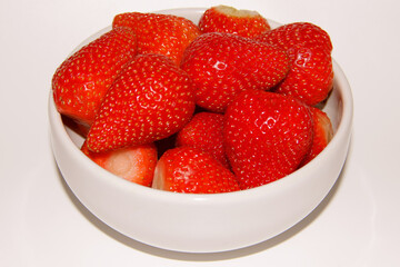 MANY STRAWBERRIES IN A WHITE BOWL ISOLATED
