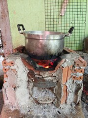 A cooking pot sits on an ancient wood stove.