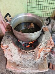 A cooking pot sits on an ancient wood stove.