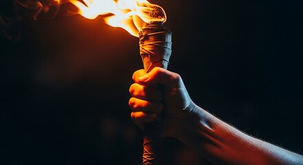 Hand Holding Burning Torch with Flame in Dark Background