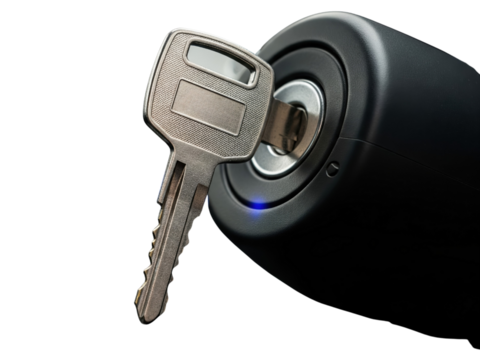 Vehicle key inserted into the ignition switch to start the engine on a transparent background