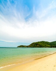 Fototapeta premium Sunny beach with turquoise sea and green hills now