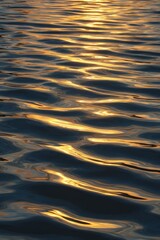 Golden Sunset Reflections Dance on Rippling Water Surface, Abstract Serenity.
