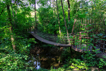 Wooden suspension bridge called "Adventure Bridge" in the Gardens of Trauttmansdorff Castle near Merano, South Tyrol, Italy