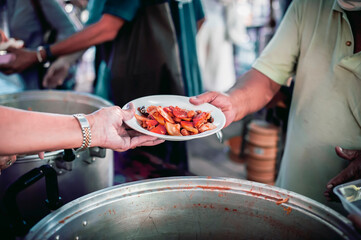 The hands of the hungry are asking for food from the donor,Out to the Homeless and Hungry