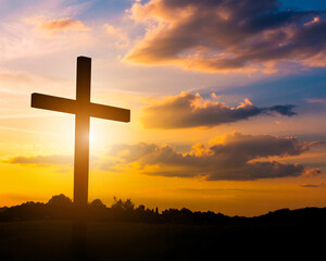 Silhouette of a cross against a vibrant sunset sky, symbolizing faith, hope, and spiritual reflection for religious themes