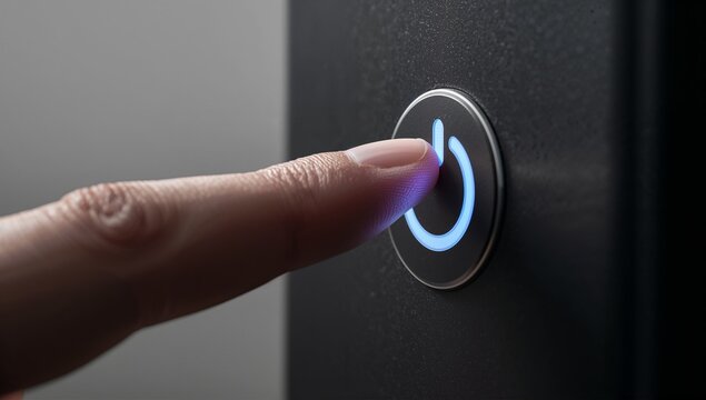 Close up of a finger touching a glowing blue power button - Powered by Adobe