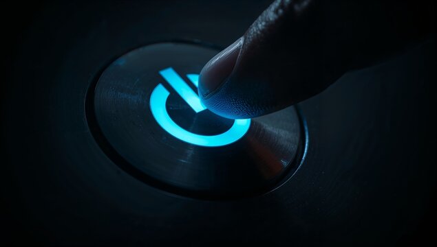 Close up of a human finger activating a neon blue power symbol button