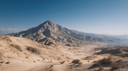 Majestic vista of desert mountain range against clear blue sky expanse