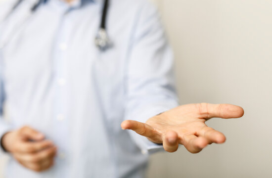 A close-up of a doctor extending his open hand. Symbolizes health, help, and support in healthcare or medical fields. Perfect for illustrating c
