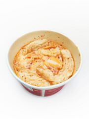 Close Up View of Indonesian Style Meatballs and Tofu in a Red and White Bowl