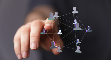 A hand touching a network diagram of people, representing connection, community, and technological advancement, embodying collaboration, communi